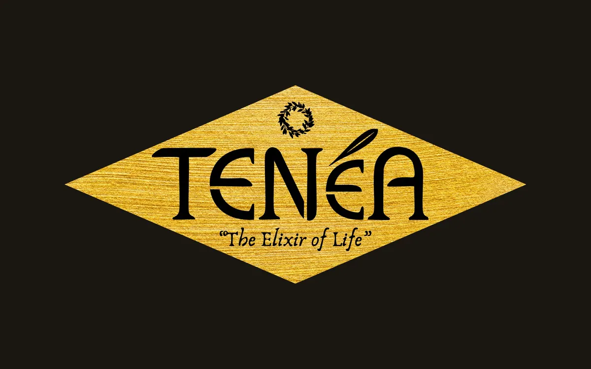 Χρυσό ρομβοειδές σήμα TENÉA με το σύνθημα The Elixir of Life